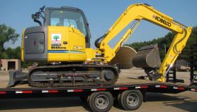 Backhoe on a trucks trailer bed